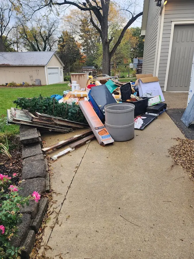 Dumpster being loaded with debris for Commercial Dumpster Rental in New Hampton